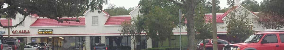 The image depicts the drive-up view of the Magnolia Layne Shopping Center in which Aza Health is located. The address is 1302 North Orange Avenue in Green Cove Springs, Florida.