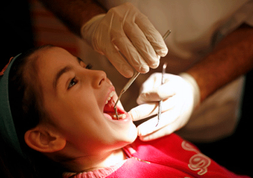 Image shows a youth dental patient during a dental exam. 